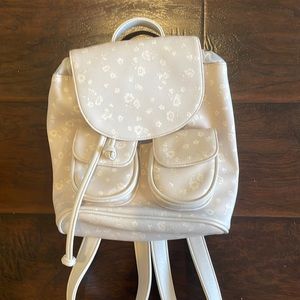 Light gray/purple backpack with white flower details